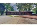Expansive backyard with a brick exterior, a large driveway, and mature trees at 3284 Salem Se Ln, Conyers, GA 30013