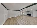 Spacious living room with sleek vinyl flooring, a fireplace, and natural light at 3284 Salem Se Ln, Conyers, GA 30013