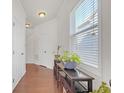 Bright hallway with hardwood floors, white trim, and ample natural light from the large window at 5711 Keys Way, Lithonia, GA 30058