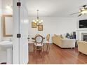 Open-concept living space with hardwood floors, chandelier, fireplace, and neutral decor at 5711 Keys Way, Lithonia, GA 30058
