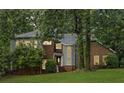 Charming two-story home with brick accents and ample windows surrounded by green grass at 175 River Run, Roswell, GA 30075