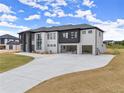 Modern two-story home with three-car garage and a concrete driveway on a spacious lot at 2021 Jones Phillips Rd, Dacula, GA 30019