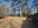 Large, grassy backyard enclosed by a chain-link fence and mature trees, offering ample space at 8118 Sw Collier Sw St, Covington, GA 30014