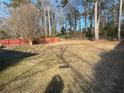 Expansive backyard with mature trees and a chain link fence, perfect for outdoor activities at 8118 Sw Collier Sw St, Covington, GA 30014