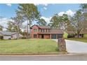 Attractive exterior view features a brick home with a spacious lawn and private driveway at 8914 Gardener Dr, Jonesboro, GA 30238
