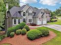 Gorgeous home with a lush, well-maintained lawn and landscape, complemented by an attached two-car garage at 2485 Millwater Xing, Dacula, GA 30019