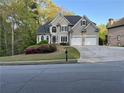 Charming home with well-manicured lawn and driveway, showcasing its curb appeal at 2485 Millwater Xing, Dacula, GA 30019