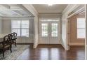 Inviting foyer with wainscoting, coffered ceiling, and a double-door entryway at 4240 Summer Breeze Way, Buford, GA 30518