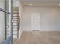Inviting entryway with hardwood floors, stairs, and ample natural light coming through the door at 533 Rubato Knl, Mcdonough, GA 30253
