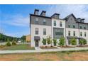 Contemporary townhouses with a brick and siding exterior, enhanced by modern architectural details and landscaping at 533 Rubato Knl, Mcdonough, GA 30253