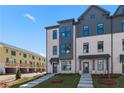 Modern townhome exterior with brick facade, gray accents, and well-maintained landscaping at 533 Rubato Knl, Mcdonough, GA 30253