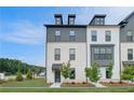 Newly built townhome with a brick facade, featuring black framed windows and freshly landscaped front yard at 533 Rubato Knl, Mcdonough, GA 30253
