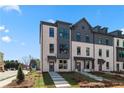 Modern townhome exterior with brick facade, gray accents, and well-maintained landscaping at 533 Rubato Knl, Mcdonough, GA 30253