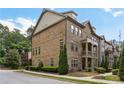 Brick townhome with manicured landscaping, offering curb appeal and a welcoming entrance at 600 Luckett Ct, Smyrna, GA 30080