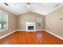 Bright living room with hardwood floors, vaulted ceilings, and a cozy fireplace at 90 Cypress Dr, Covington, GA 30016