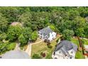 High aerial of home with gray roof in a wooded neighborhood on a cul-de-sac at 9206 Denmeade Trce, Douglasville, GA 30135