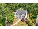 Aerial view of a traditional home with manicured lawn surrounded by mature trees at 9206 Denmeade Trce, Douglasville, GA 30135