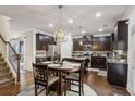 Spacious eat-in kitchen with dark cabinetry, stainless steel appliances, granite countertops, and a central island at 6977 Demeter Dr, Atlanta, GA 30349