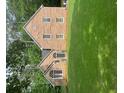 Charming brick two-story home with arched window and lush green lawn at 8035 Canter Ln, Alpharetta, GA 30009