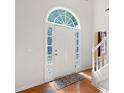 Bright foyer featuring an arched window over the front door and decorative stained-glass side windows at 8035 Canter Ln, Alpharetta, GA 30009