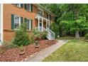 Inviting front entrance with white stairs, brick facade, and lush landscaping at , Marietta, GA 30064