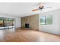 Bright living room boasts a stone fireplace, sleek hardwood floors, and access to a sunroom at 1104 Country Ct, Lawrenceville, GA 30044
