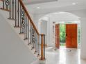Elegant entryway features a staircase with iron railings, hardwood steps, and a stunning doorway at 130 Robin Rd, Marietta, GA 30067