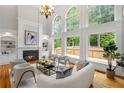 Bright living room with floor-to-ceiling windows, a fireplace, and stylish neutral-toned furniture at 130 Robin Rd, Marietta, GA 30067