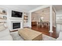 Open-concept living room showcasing a fireplace, built-in shelving, and hardwood floors at 3694 Lambert Ne Ln, Atlanta, GA 30319