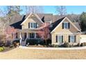 Beautiful two-story house showcases a cozy front porch, meticulously landscaped yard, and classic architectural design at 103 Old Avery Dr, Canton, GA 30115