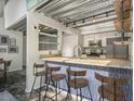 Modern kitchen with stainless steel appliances, granite counters, and eat-in bar with wood stools at 195 Arizona Ave # 179, Atlanta, GA 30307