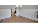Open dining area features hardwood floors and decorative wall paneling at 541 Glen Abbey Se Cir, Mableton, GA 30126