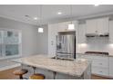 Modern kitchen features stainless steel appliances, granite counters, and a center island at 541 Glen Abbey Se Cir, Mableton, GA 30126