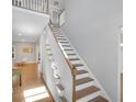 Bright foyer showcases a staircase with wood treads and white risers at 541 Glen Abbey Se Cir, Mableton, GA 30126