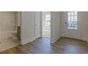 View of modern bathroom, neutral paint and wood floors, and a doorway to additional rooms at 64 Lakeview Pt, Dallas, GA 30157