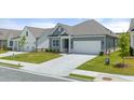 Beautiful one-story house featuring a well-kept lawn and a spacious two-car garage with a concrete driveway at 64 Lakeview Pt, Dallas, GA 30157