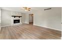 Spacious living room with stone fireplace and hardwood floors at 708 Wind Song Trce, Woodstock, GA 30189