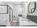 Modern bathroom with double sinks, sleek vanity, and a glass-enclosed shower at 1211 Mortimer Se Pl, Atlanta, GA 30317