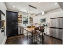 Well-lit kitchen with stainless steel appliances, white cabinets, and an eat-in area at 1211 Mortimer Se Pl, Atlanta, GA 30317