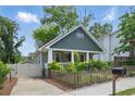 View of charming house with a well-maintained lawn, walkway, driveway, and a cozy front porch at 2610 Cheney St, Atlanta, GA 30344