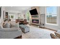 Open concept living room with stone fireplace, hardwood floors, and stylish furnishings at 2610 Cheney St, Atlanta, GA 30344