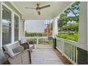 Inviting front porch featuring comfortable seating, ceiling fan, and a tranquil outdoor space at 2610 Cheney St, East Point, GA 30344