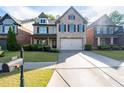 Attractive brick home featuring a well-maintained lawn, landscaping, and a convenient two-car garage at 2800 Tuscany Park Dr, Lawrenceville, GA 30043