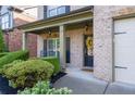Inviting front porch with stylish columns, manicured shrubs, and a charming wreath on the front door at 2800 Tuscany Park Dr, Lawrenceville, GA 30043