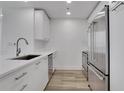 Modern kitchen with stainless steel appliances, white cabinets, and sleek countertops at 3324 Peachtree Ne Rd # 2004, Atlanta, GA 30326