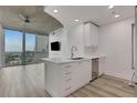 Open-concept living space featuring a kitchen island and large sliding glass doors at 3324 Peachtree Ne Rd # 2004, Atlanta, GA 30326