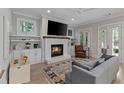 Bright living room with a brick fireplace, built-in cabinets, and French doors leading to the outside at 357 Mell Ave, Atlanta, GA 30307
