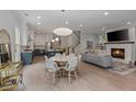 Open-concept living space with a fireplace, modern furnishings, and a view of the kitchen and staircase at 357 Mell Ave, Atlanta, GA 30307