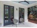Inviting outdoor seating area with white-painted floor, ceiling fan, seating, and stylish outdoor lighting at 357 Mell Ave, Atlanta, GA 30307
