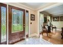 Inviting foyer featuring tile flooring, decorative glass door and sidelights, adjacent to a sitting room at 3592 Midvale Cv, Tucker, GA 30084